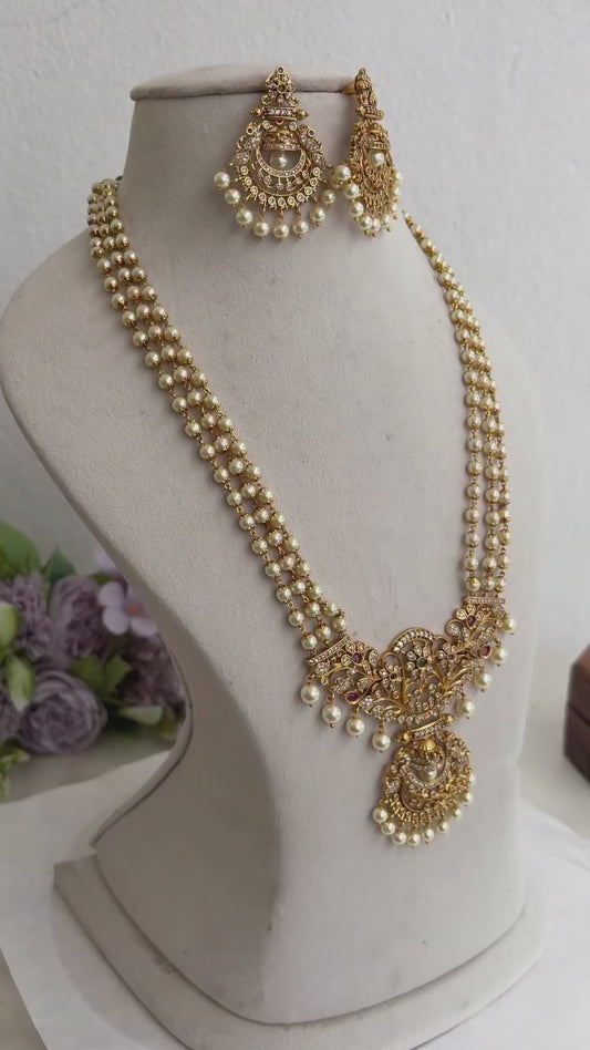 Elegant Three Layer Pearl Necklace with Floral Motif Pendant Drop